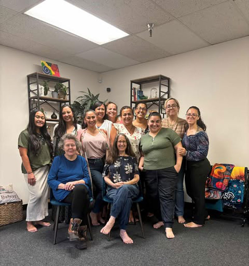 Group photo of the Holistic Healers Community members gathered in a welcoming space, smiling together.